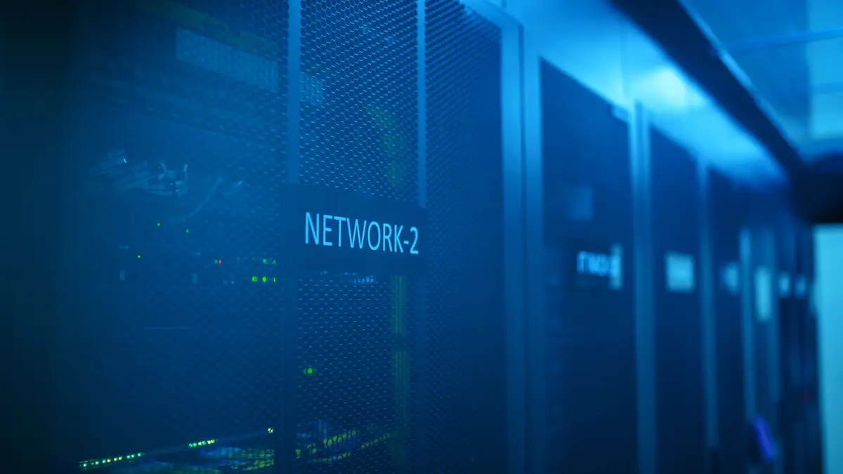 Network rack in a server room lit in blue